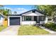 Cozy home exterior showing a front yard, garage, and charming front porch at 819 State Ave, Daytona Beach, FL 32117