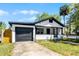 Charming exterior exhibiting a front yard, single-car garage, and inviting front porch at 819 State Ave, Daytona Beach, FL 32117
