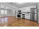 Kitchen with stainless steel appliances and white cabinets with adjacent dining and living spaces at 819 State Ave, Daytona Beach, FL 32117