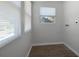 The laundry room features a window, washer hookups, vinyl floors, and white walls at 819 State Ave, Daytona Beach, FL 32117