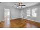 Spacious living room featuring hardwood floors, neutral walls, and large windows with a ceiling fan at 819 State Ave, Daytona Beach, FL 32117