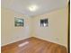 Bright bedroom featuring wood-look flooring, neutral walls, and two windows at 831 Wolf Trl, Casselberry, FL 32707