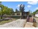 Charming single-story home featuring a ramp to the screened porch and well-kept landscaping at 831 Wolf Trl, Casselberry, FL 32707