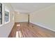 Bright living room with wood floors, a large window, and a view of the outdoors at 831 Wolf Trl, Casselberry, FL 32707