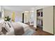 Bright primary bedroom featuring a large bed, hardwood floors, and ensuite bathroom at 831 Wolf Trl, Casselberry, FL 32707
