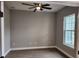 Bright bedroom features a ceiling fan and large window at 947 Ferne Dr, Longwood, FL 32779