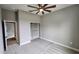 Neutral bedroom with large closet, lighted ceiling fan, and entry to ensuite bathroom exudes comfort and convenience at 947 Ferne Dr, Longwood, FL 32779