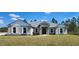 Charming single-story home with stone accents, a metal roof and shutters on a well-maintained lawn at 947 Ferne Dr, Longwood, FL 32779