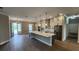 Spacious kitchen with island, white cabinetry, wood-look floors, and stainless-steel refrigerator at 947 Ferne Dr, Longwood, FL 32779