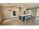 Open concept kitchen featuring white cabinets, stainless steel appliances and large kitchen island at 947 Ferne Dr, Longwood, FL 32779