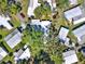 Overhead shot of community homes nestled among mature trees, well-kept properties, and a tranquil atmosphere at 105 Canal Vw, Eustis, FL 32726