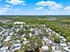 Sprawling aerial view of a mobile home community, abundant greenery, and distant wooded areas at 105 Canal Vw, Eustis, FL 32726