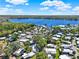 An aerial view of a community, showing a lake and lush vegetation under a partly cloudy sky at 105 Canal Vw, Eustis, FL 32726