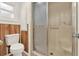 Clean and bright bathroom with shower and toilet, featuring wood-paneled accents at 105 Canal Vw, Eustis, FL 32726
