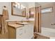 Cozy bathroom with framed mirror, neutral color scheme, and shower/tub combo at 105 Canal Vw, Eustis, FL 32726