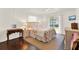 Bright bedroom featuring a queen bed, hardwood floors, and sliding door at 105 Canal Vw, Eustis, FL 32726