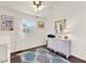 Bright bedroom featuring hardwood floors, a ceiling fan, and charming wicker dresser at 105 Canal Vw, Eustis, FL 32726