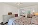 Bright bedroom with shell patterned bedspread, ensuite bathroom, and dresser at 105 Canal Vw, Eustis, FL 32726