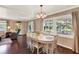 Spacious dining room featuring hardwood floors and scenic outdoor views through large windows at 105 Canal Vw, Eustis, FL 32726