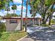 Single-story home with a covered carport and mature landscaping, and a charming facade at 105 Canal Vw, Eustis, FL 32726