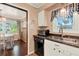 Close-up view highlighting the kitchen sink area, with natural light and dark countertops at 105 Canal Vw, Eustis, FL 32726