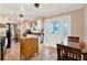 Bright kitchen featuring white cabinets, tile flooring, breakfast nook, and a decorative glass door at 105 Canal Vw, Eustis, FL 32726