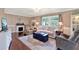 Cozy living room featuring wood paneled walls, fireplace, and plush seating at 105 Canal Vw, Eustis, FL 32726