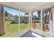 Enclosed porch with views of the lush backyard and surrounding greenery at 105 Canal Vw, Eustis, FL 32726