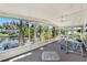 Spacious screened porch featuring waterfront views, seating, and exercise equipment at 105 Canal Vw, Eustis, FL 32726