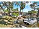Charming waterfront view featuring a boat dock, lush greenery, and well-maintained landscaping at 105 Canal Vw, Eustis, FL 32726