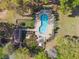 Overhead shot of a community pool boasting chairs, tables, manicured bushes, and fencing at 1233 Bramley Ln, Deland, FL 32720