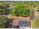 The aerial view showcases the roof with installed solar panels, complemented by lush mature landscaping at 1233 Bramley Ln, Deland, FL 32720