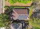 This aerial view reveals a well-maintained roof with solar panels and a green, landscaped yard at 1233 Bramley Ln, Deland, FL 32720
