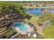 The community pool boasts ample seating and a large lake in the background at 1233 Bramley Ln, Deland, FL 32720