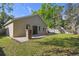 Enjoy the lush green lawn and extended patio with stacked stone features for a serene outdoor living space at 1233 Bramley Ln, Deland, FL 32720