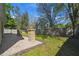 Enjoy the lush green lawn and extended patio with stacked stone features for a serene outdoor living space at 1233 Bramley Ln, Deland, FL 32720