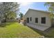 Enjoy the lush green lawn and extended patio with stacked stone features for a serene outdoor living space at 1233 Bramley Ln, Deland, FL 32720