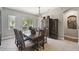 Elegant dining room with a large window, wooden table, and unique chandelier at 1233 Bramley Ln, Deland, FL 32720