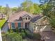 Beautiful home showcasing brown shingled roof, stone accents, manicured landscaping, and inviting two-car garage at 1233 Bramley Ln, Deland, FL 32720