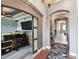 Hallway view with decorative rug, wall decorations, and arched doorway leading to living space at 1233 Bramley Ln, Deland, FL 32720