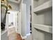 Hallway with wood flooring, built-in shelving, and views to other parts of the home at 1233 Bramley Ln, Deland, FL 32720