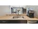 Bright kitchen with a dual basin sink and stainless steel dishwasher under a breakfast bar at 1233 Bramley Ln, Deland, FL 32720