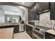 Modern kitchen featuring stainless steel appliances, dark wood cabinets, and stylish backsplash at 1233 Bramley Ln, Deland, FL 32720