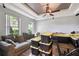 Bright living room featuring neutral walls, tray ceiling, wood-look floors, and natural light at 1233 Bramley Ln, Deland, FL 32720