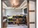 Partially cluttered living room with gray walls, a tray ceiling, a ceiling fan, and wood-look floors at 1233 Bramley Ln, Deland, FL 32720