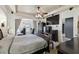 Main bedroom with a large bed, TV, and access to an adjacent room at 1233 Bramley Ln, Deland, FL 32720