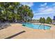Fenced-in community pool offering lounge chairs, tables, and landscaping at 1233 Bramley Ln, Deland, FL 32720
