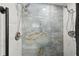 Walk-in shower featuring dual shower heads and marble-look tiling at 1233 Bramley Ln, Deland, FL 32720
