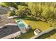 Aerial view of home's backyard showcasing pool, gazebo, shed, and fenced yard at 12720 Greco Dr, Orlando, FL 32824