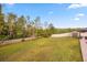 Spacious backyard with green grass and a white fence, perfect for outdoor activities at 12720 Greco Dr, Orlando, FL 32824